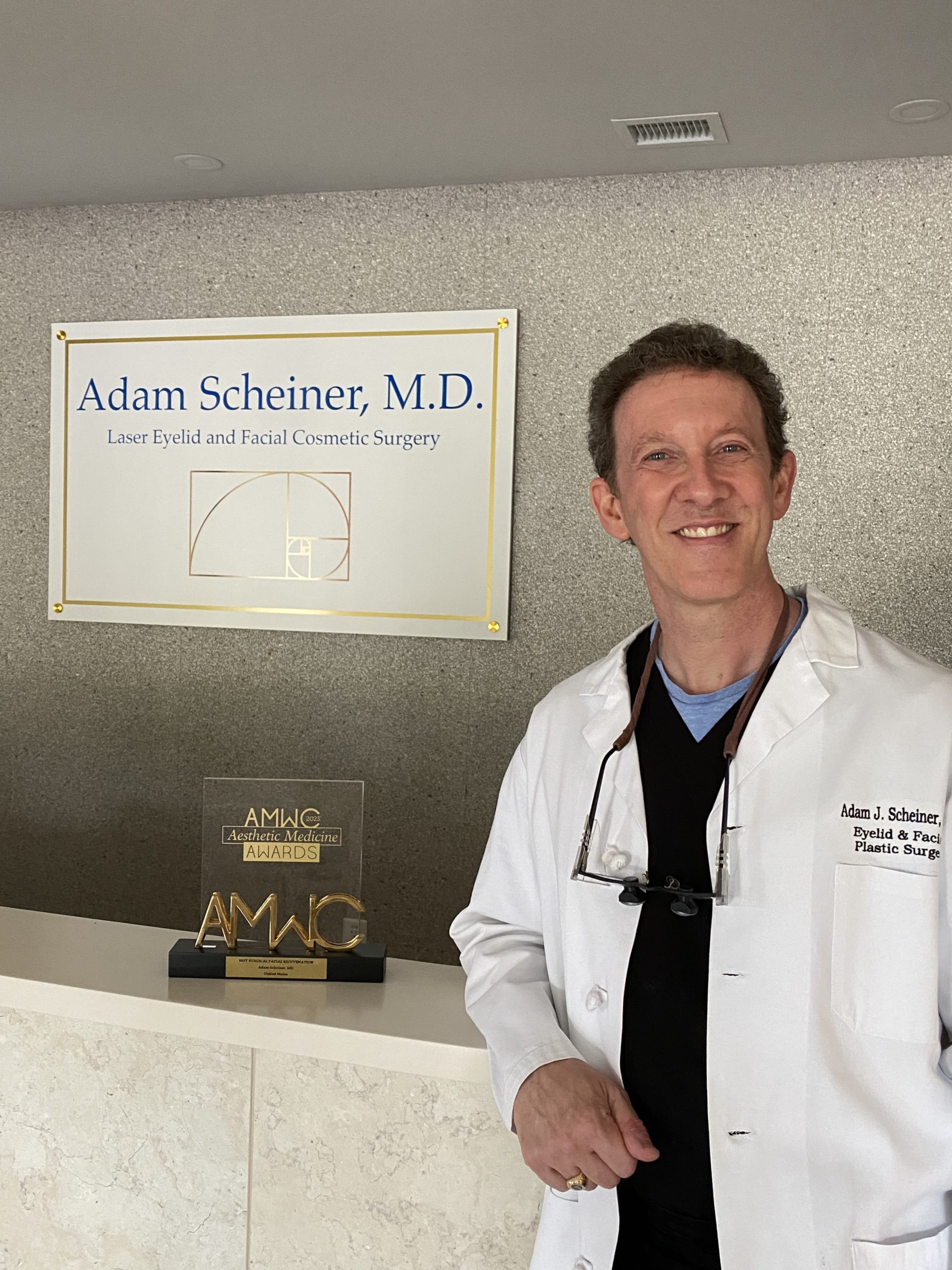 Dr. Scheiner standing in front of the reception desk of his practice.