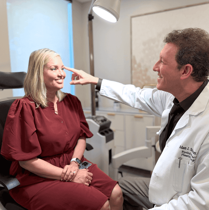 Adam sits with a patient while discussing her RESET treatment.